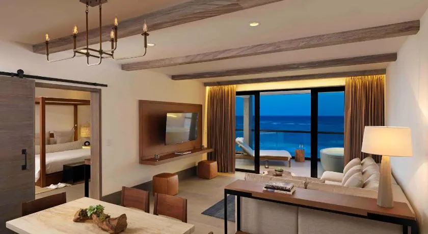 Stunning modern room overlooking the water at one of the best adult only all inclusive resorts in Tulum. 