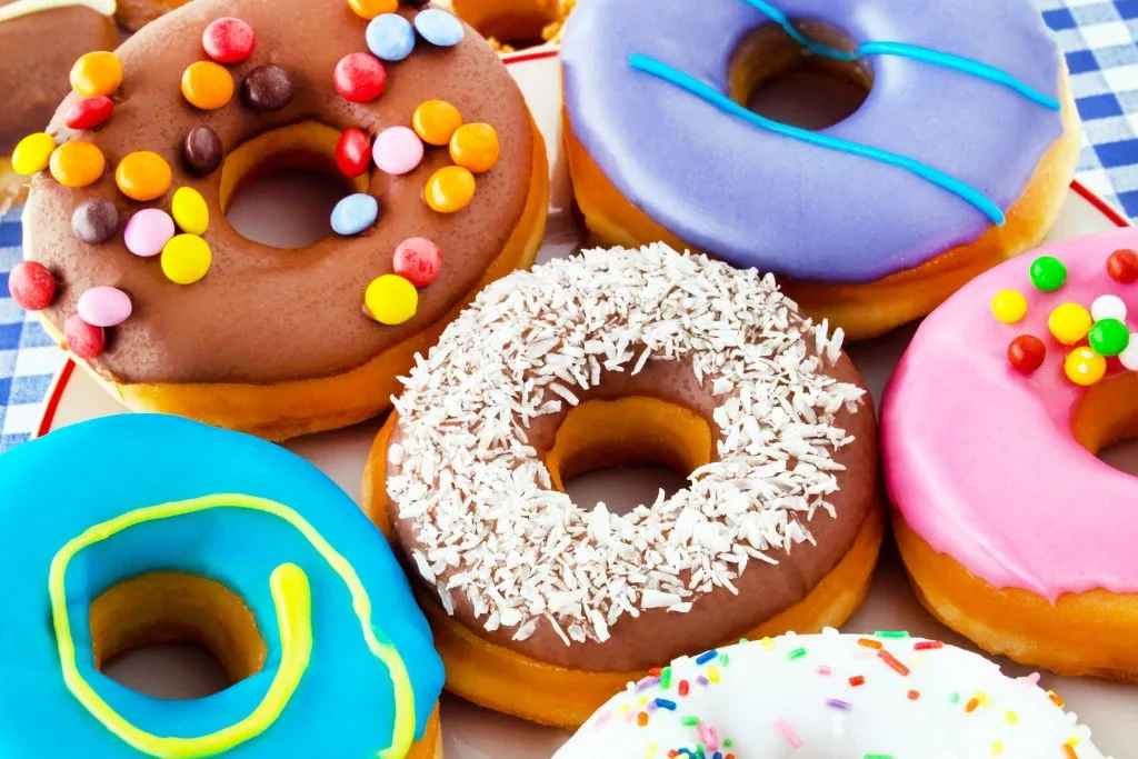 An assortment of donuts with colorful icing. 