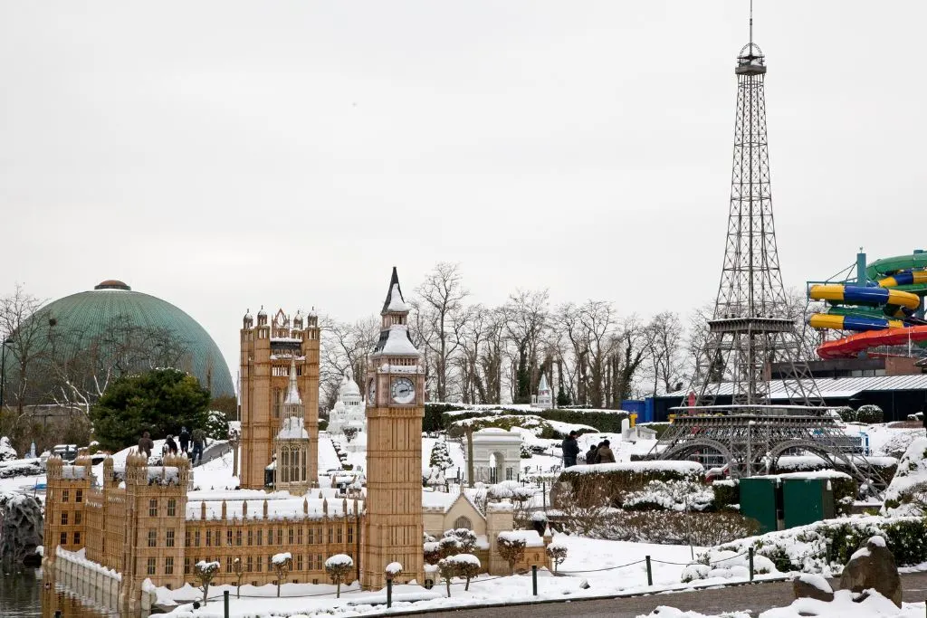 View of Mini Europe where the Eiffel Tower and Big Ben are covered in snow as you enjoy the many cool things to do in Brussels. 