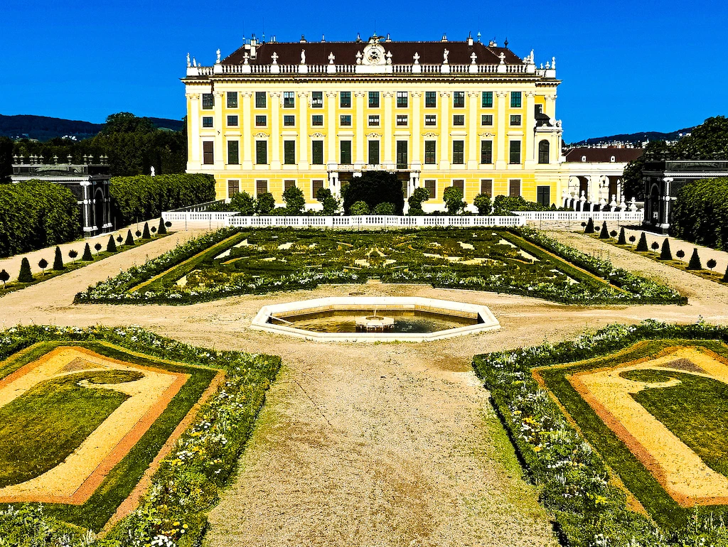 Yellow exterior of Schönbrunn Palace and the beautiful gardens there. 