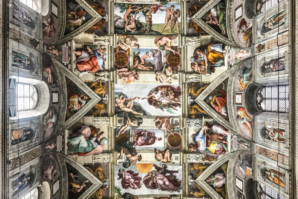 View of the ornate ceiling of the Sistine Chapel during a Vatican at night tour.