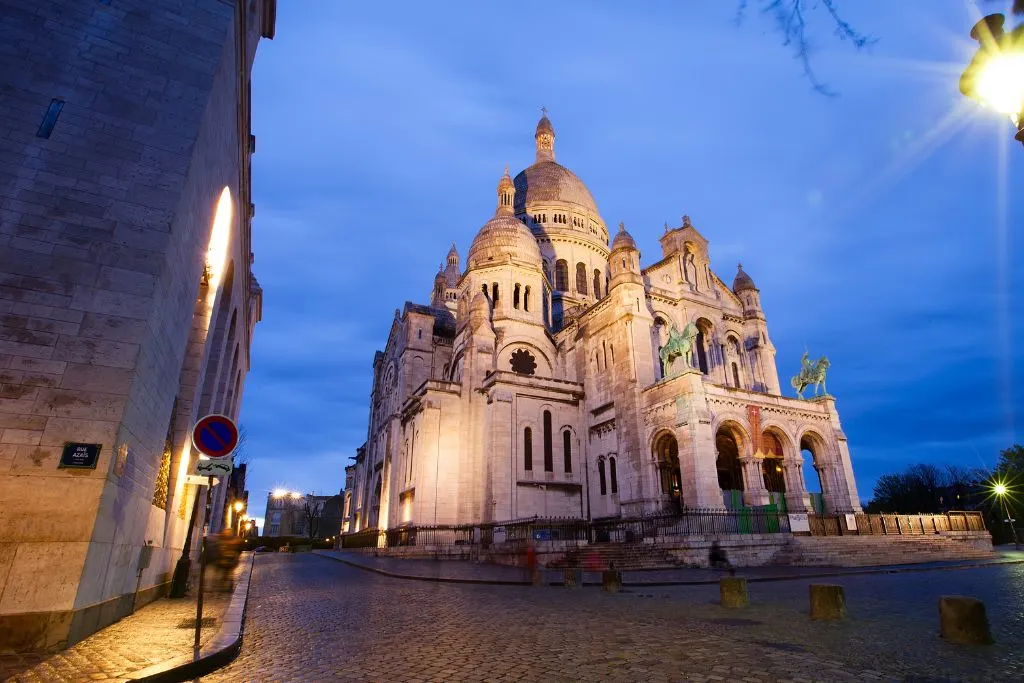 View of Basilica of Sacre-Coeur at night. in Montmartre during one of the best Paris night tours. 