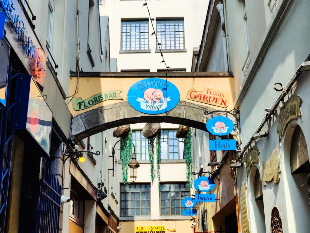 A view of the pink elephant on a blue sign that represents Delirium Cafe in Brussels.