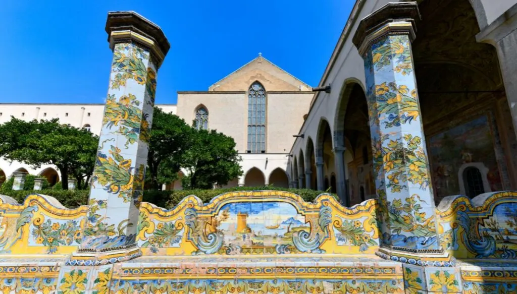 The Monumental Complex of Santa Chiara features stunning columns that are made up up of tiles that look like green leaves with yellow flowers. In the middle of the two columns you have a seat with a tiled mosaic of a scene in Naples. So, this garden is a must-see during your 1 day in Naples Italy itinerary. 