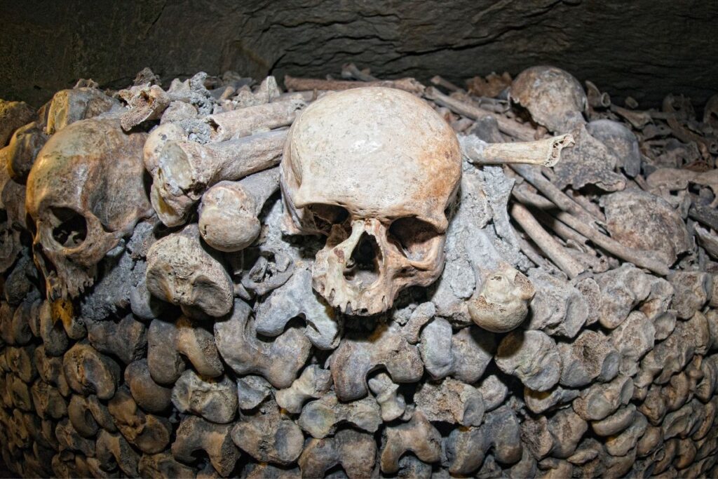View of a ghoy that lines the catacombs of Rome with bones around it. This is oen of the best ghost tours in Rome. 