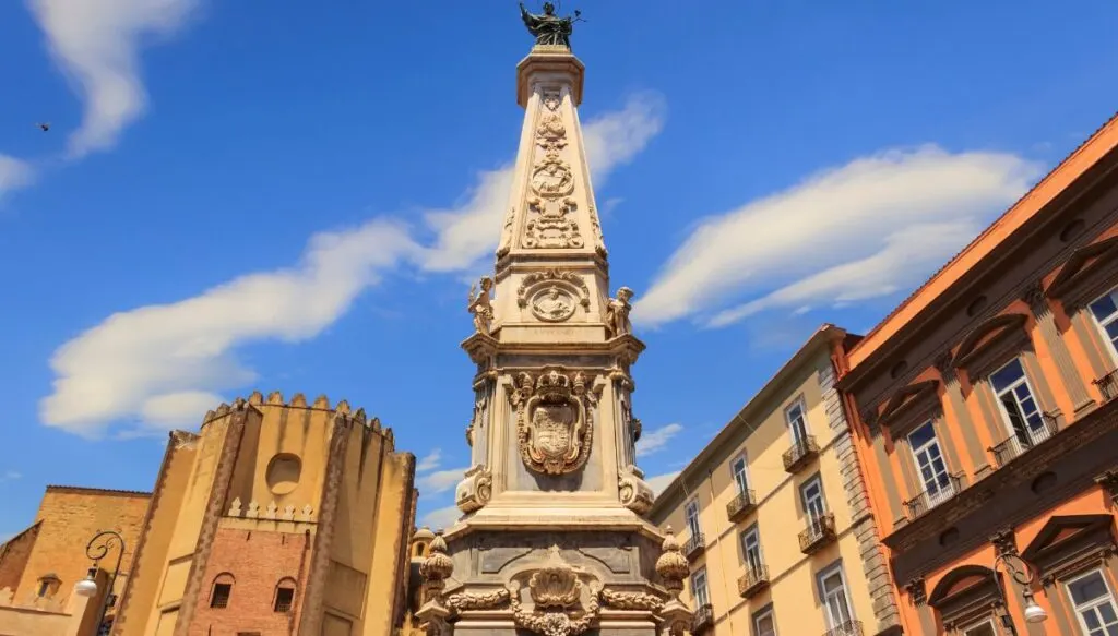 Large carved column with a statue on the top that sits in the center of Naples in in Piazza del Ges&ugrave; Nuovo. It is a must-see during your 24 hours in Naples. 