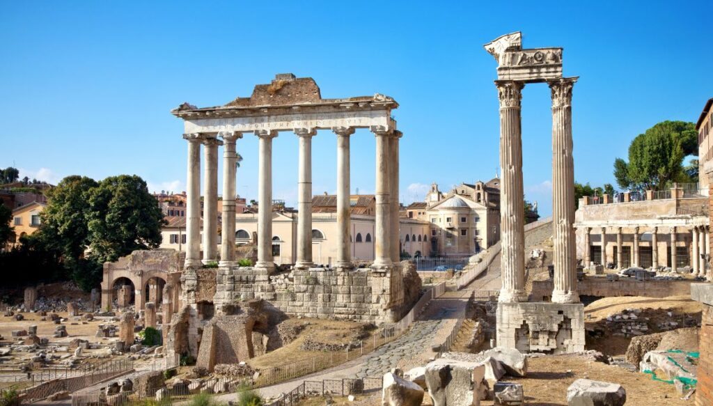 A view of the ancient ruins and old columns of the Forum in Rome. Definitely visit when you solo travel Rome. 