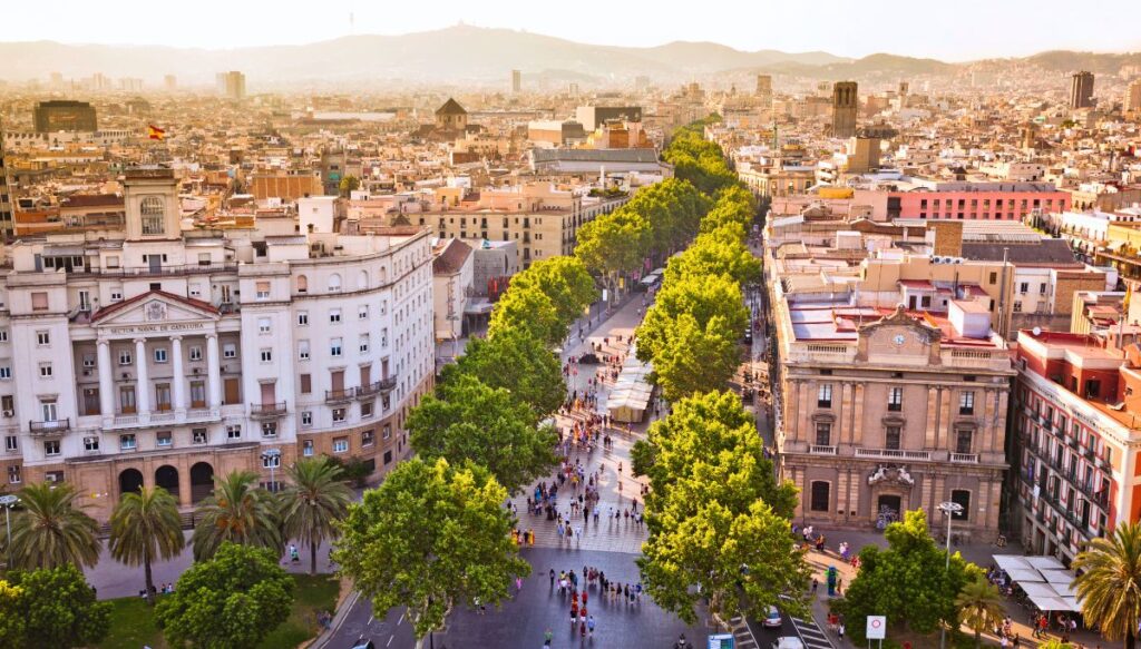 Aerial view of Las Ramblas in Barcelona. It is a pedestrian walkway surrounded by trees and buildings in the center of the center. You'll also find some of the best hostels in Barcelona here. 