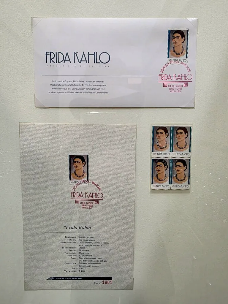 You can see a copy of a letter and an envelope with Frida Kahlo stamps on it. 