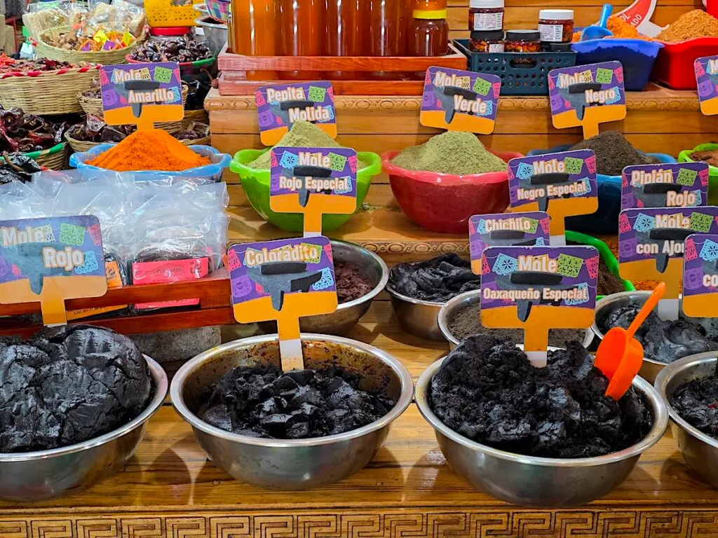 View of different types of moles for sale in metal bowls in a local market in Oaxaca city. 