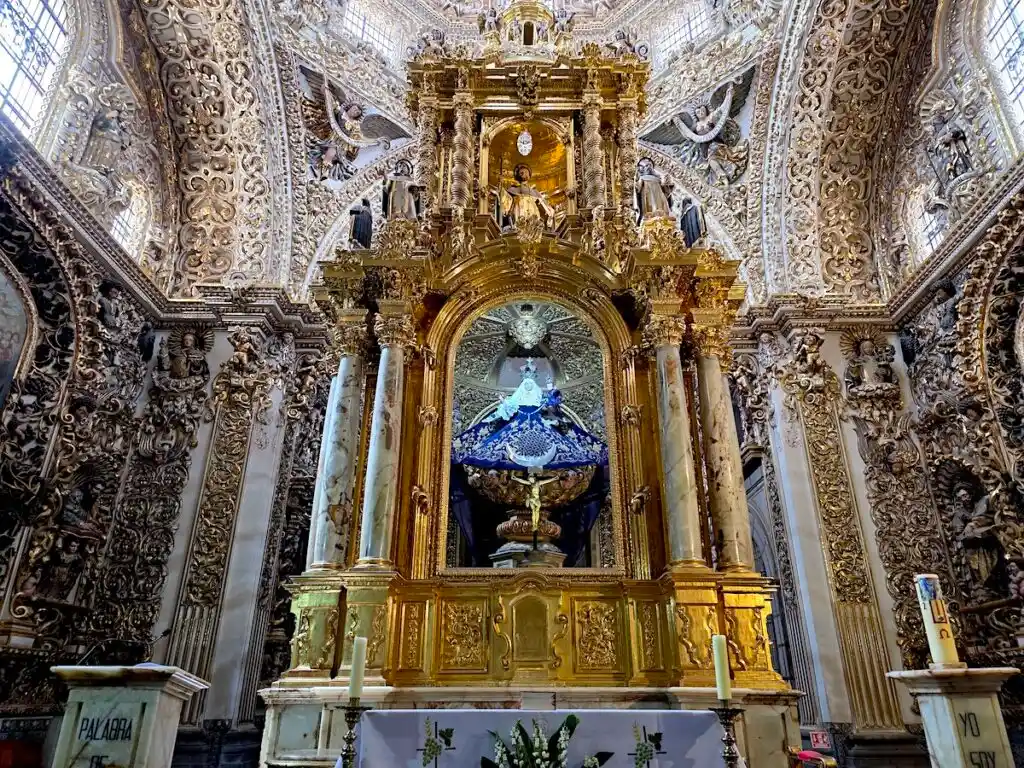 View of the orante gold interiro of the Capilla del Rosario from inside the Templo de Santo Domingo. 
