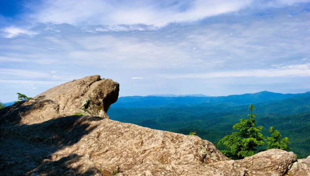 View from the top of a rock and an  overlook in Blowing Rock Park in North carolina with beautiful views of mountains. 