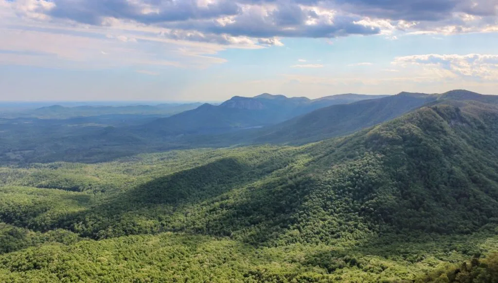 View of rolling green hills from the top of Caesar's Head in South Carolina on a clear day. 