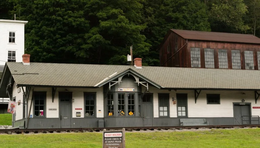 View of a vintage gray railroad station in Cass Scenic Railroad State Park. 