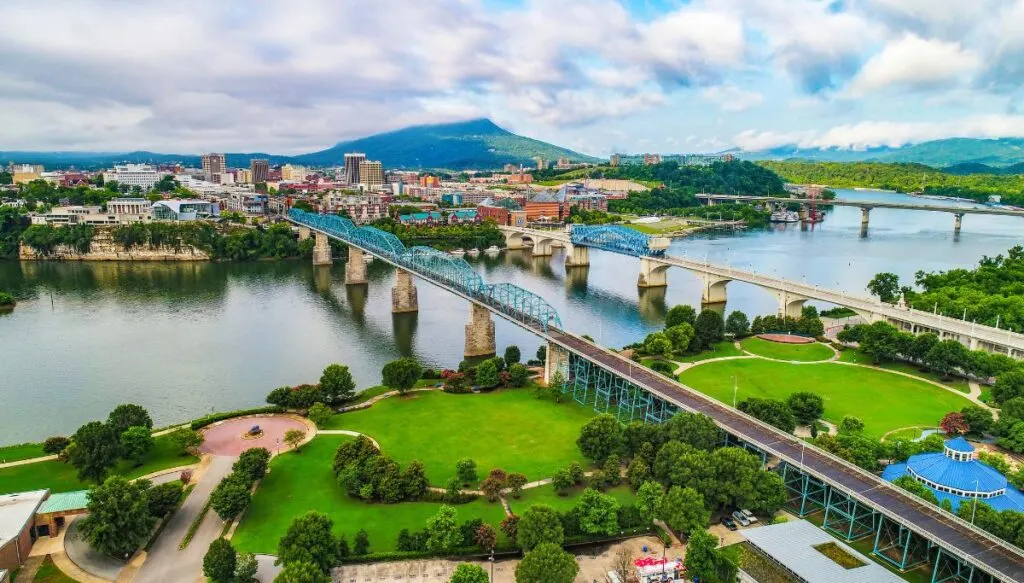 Aerial view of Chattanooga with three bridges across a river leading into the city. 