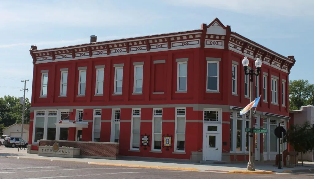 View of the small, Colonial-style, red town hall in Lindsborg. 