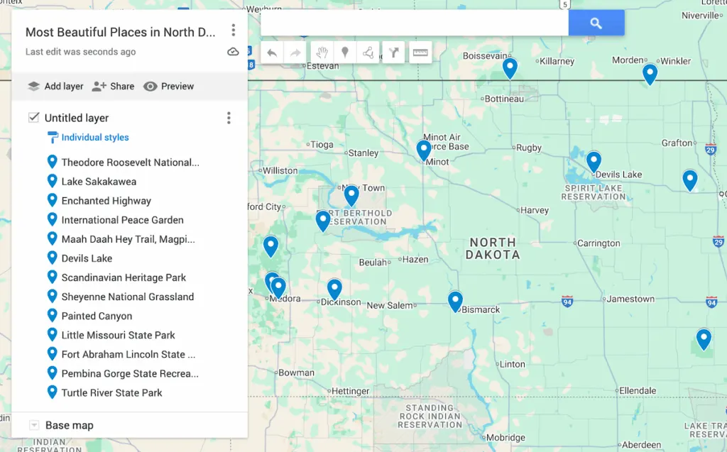 Map of North Dakota with 13 blue dots to represent the most beautiful places in North Dakota.