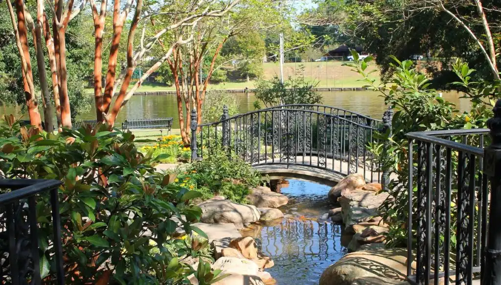 View of a quaint graden along the river with a bridge going over a small stream in Natchitoches, Louisiana. 