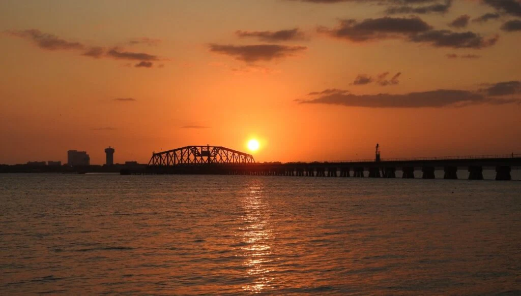 View of the sun setting over the train tracks and bridge near Ocean Springs, Mississippi. 
