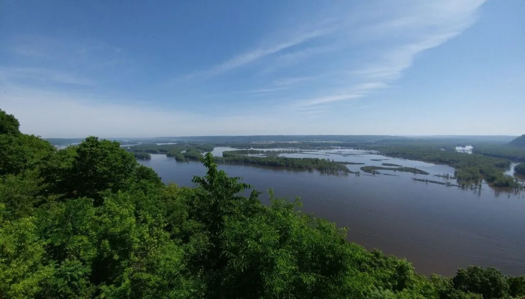 Aerial view of the lakes and rivers surrounded by pine trees inside of Pike's Peak State Park in Iowa. 