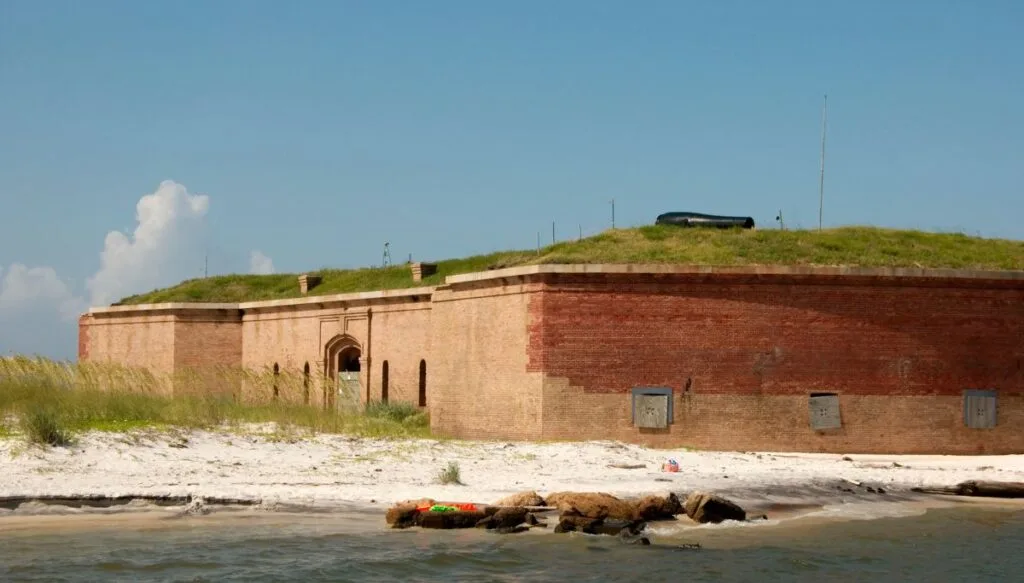 View of an old brick fort on Ship Island surrounded by white sand beaches. 