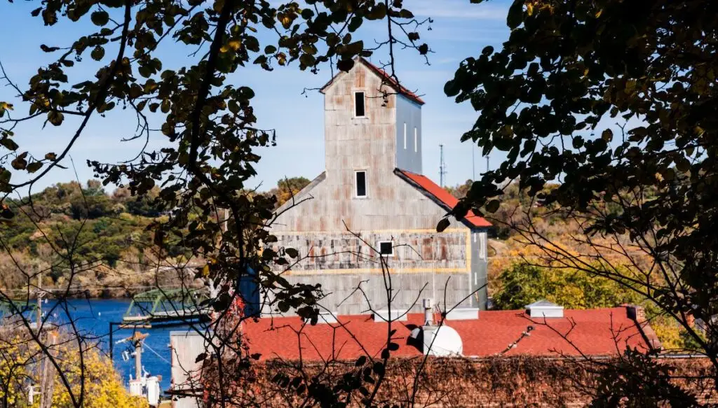 View of a gray mill sitting along the water in Stillwater, Minnesota. 