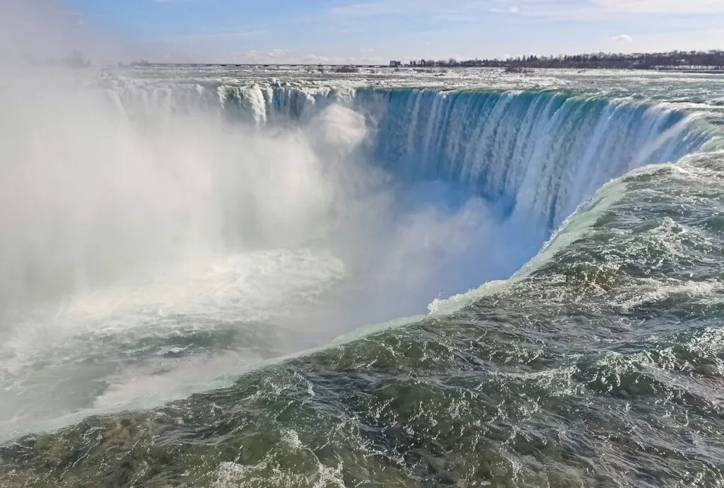 A close up view of Niagara Falls on a sunny day in the winter. 