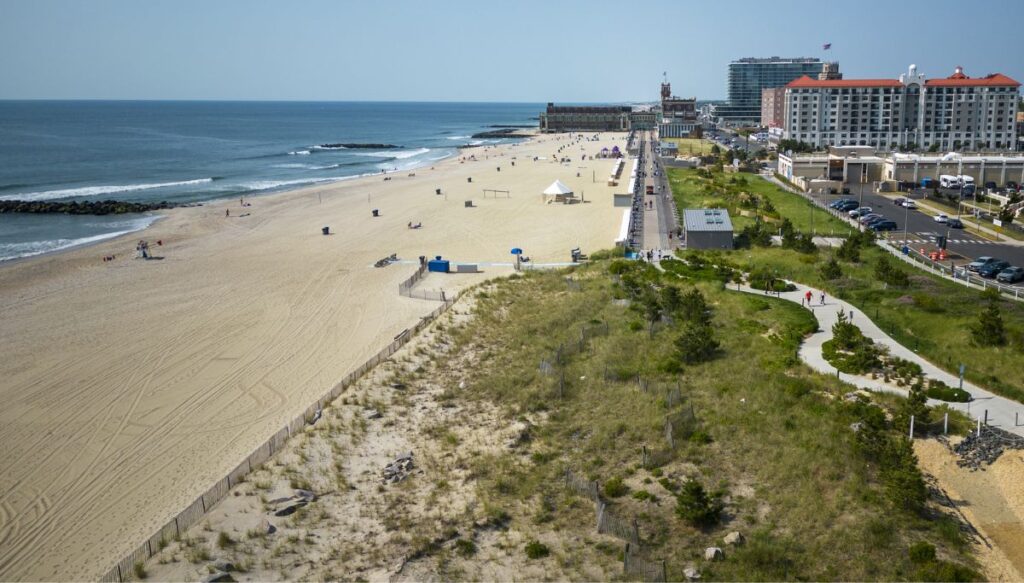 Aerial view of the beach at Asbury Park. The beach is on the left and the hotels are on the right. You can see the ocean to the left as well.