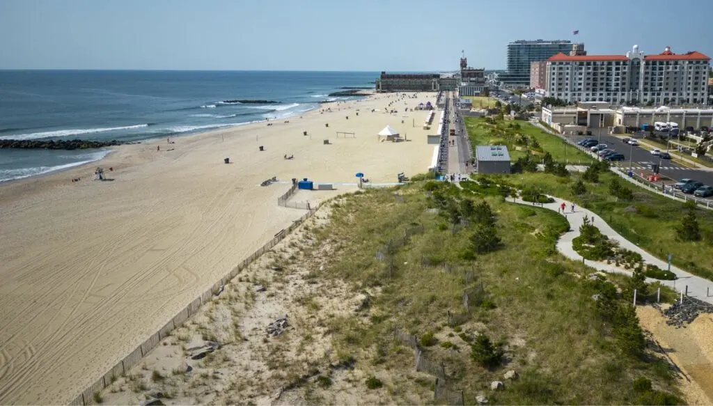 Aerial view of the beach at Asbury Park. The beach is on the left and the hotels are on the right. You can see the ocean to the left as well. 