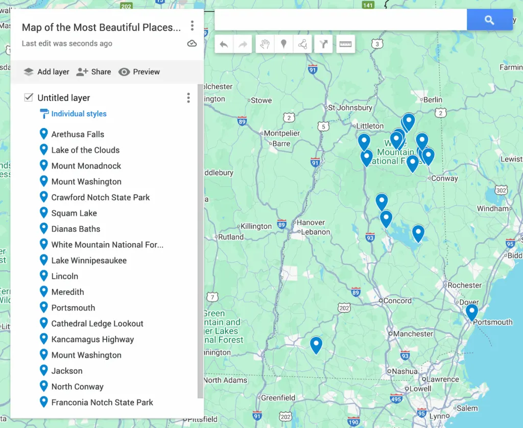 View of a map of New Hampshire with 17 blue dots to represent the most beautiful places in New Hampshire. 