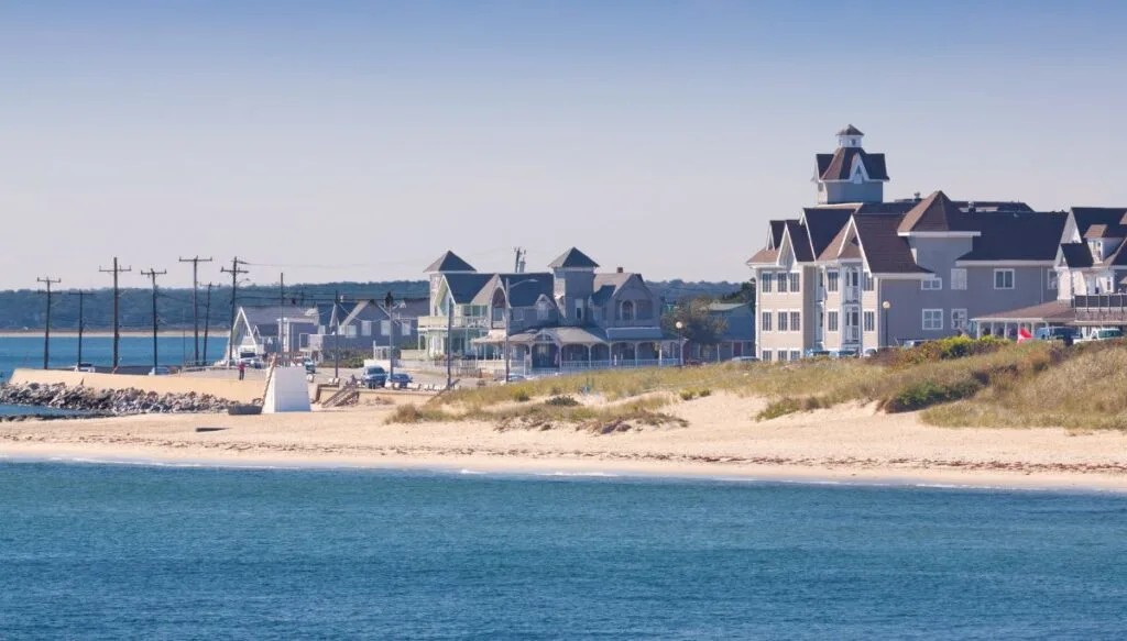 View of the giant white homes sitting along the beach on a sunny day in Martha's Vineyard. 