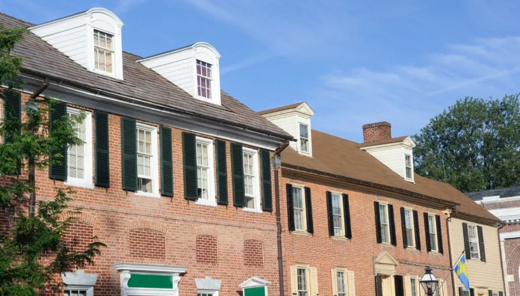 View of the exterior of old brick, Colonial-style homes lining the streets of the downtown area in New castle. 