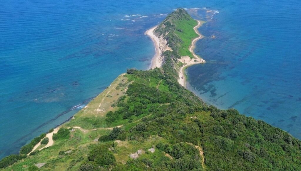Aerial vies of the bright green lands that make up the Cape of Rodon in Albania.