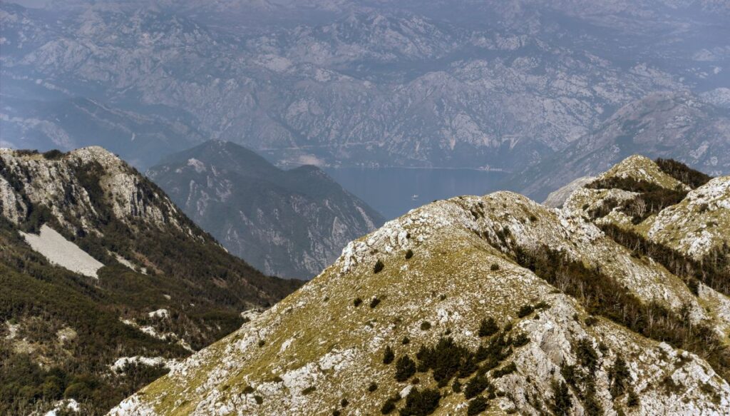 View of the rock covered mountains and the bay in the background in  Lovćen National Park. 