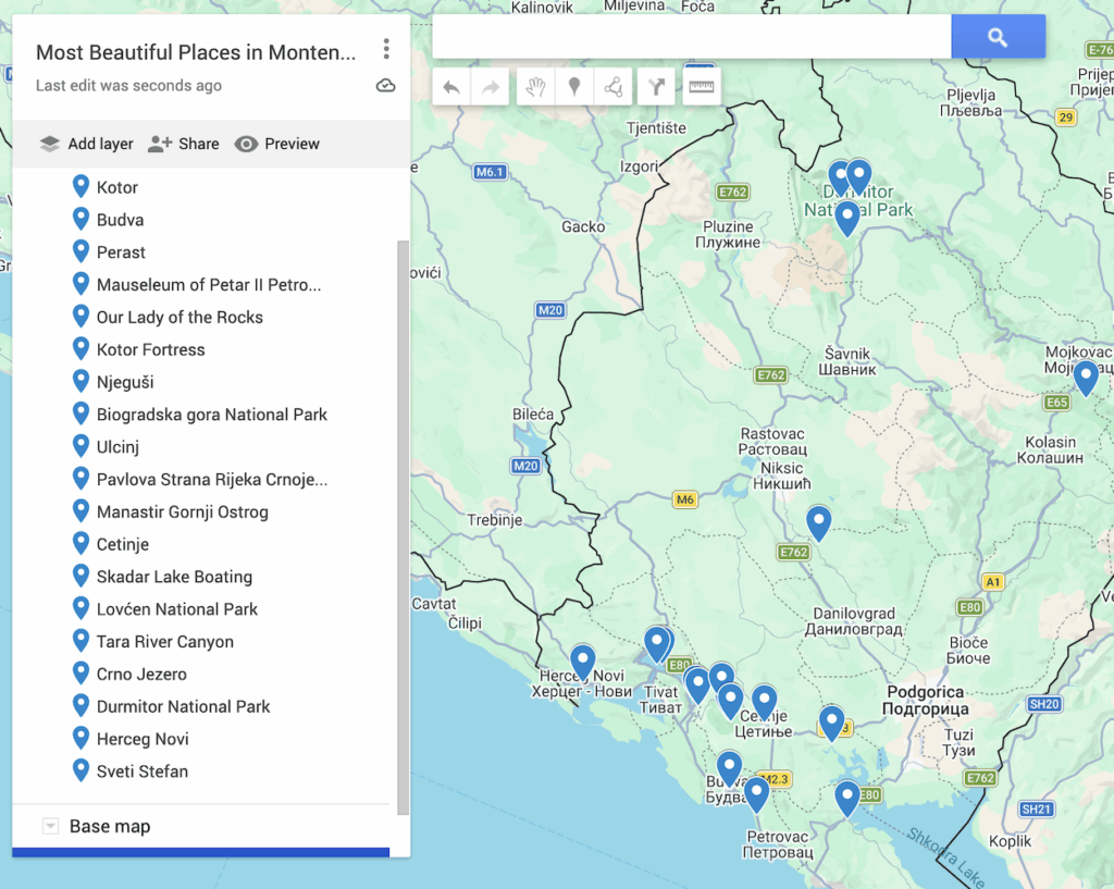 View of 19 blue dots that represent the most beautiful places in Montenegro on a map of the country. 
