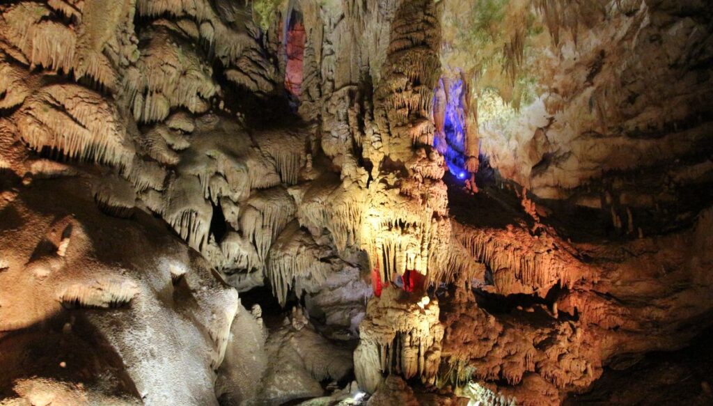 View of the various rock formations all lit up on the ceiling of Prometheus Cave in Georgia. 