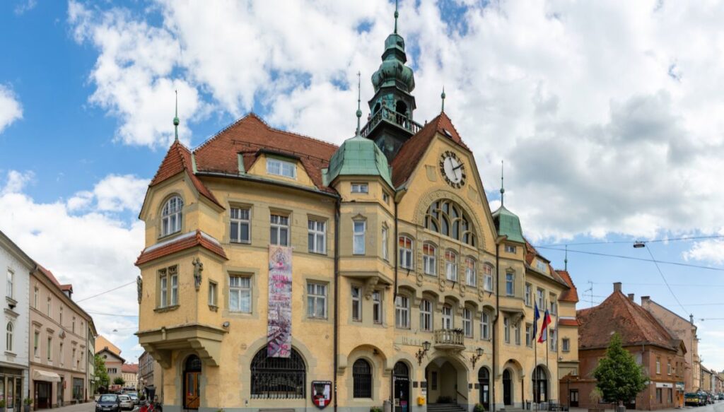 View of the yellow city hall with an old world feel in Ptuj, Slovenia.