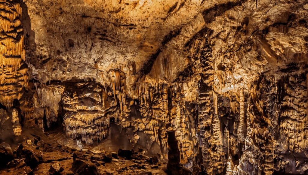 View of the interior of Baradle Cave inside of Aggtelek National Park in Hungary. The interior was all lit up with stone structures.