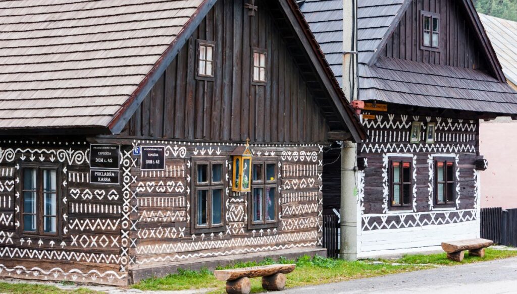 View of the unique wooden homes with white designs on them in the town Čičmany, Slovakia.