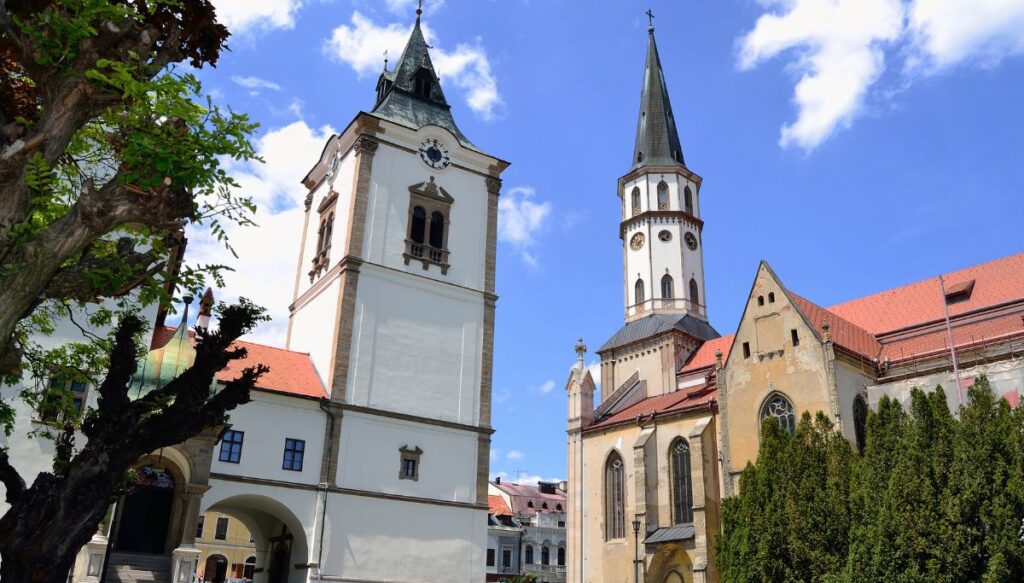 View of historic white church buildings in the center of Levoča in Slovakia.